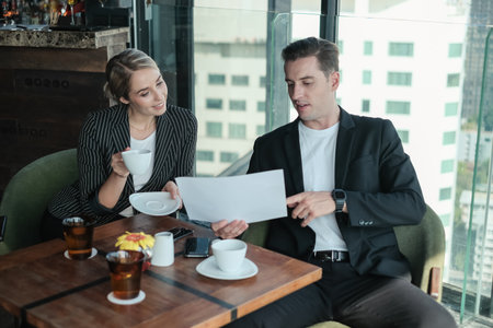 Two businessman and businesswoman couple meeting in co working space at sky lounge or officeの写真素材