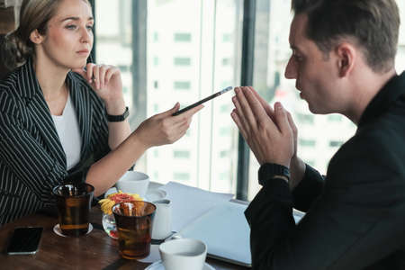 Two businessman and businesswoman couple meeting in co working space at sky lounge or officeの写真素材