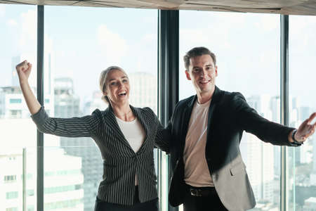 Two businessman and businesswoman couple meeting in co working space at sky lounge or officeの写真素材