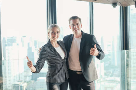 Two businessman and businesswoman couple meeting in co working space at sky lounge or officeの写真素材