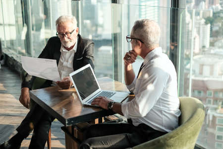 Two Senior businessman couple meeting in co working space at skyscraper lounge or officeの写真素材