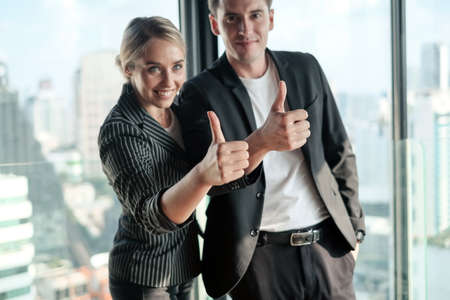Two businessman and businesswoman couple meeting in co working space at sky lounge or officeの写真素材