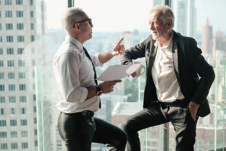 Two Senior businessman couple meeting in co working space at skyscraper lounge or officeの写真素材