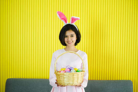 Portrait beautiful young asian girl with painted eggs, Happy easter dayの写真素材