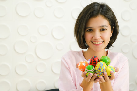Portrait beautiful young asian girl with painted eggs, Happy easter day