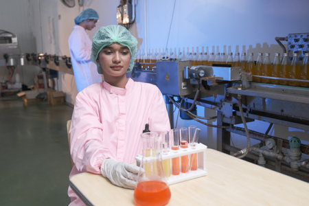South asia female laboratory assistant or woman expert quality staff is test liquid in factory or labの写真素材