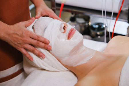 Beautiful woman having a facial massage in spa salon. Beauty treatment concept.の写真素材