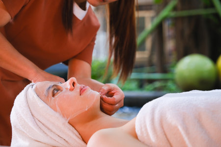 Beautiful woman getting facial massage in spa salon. Beauty treatment concept.の写真素材