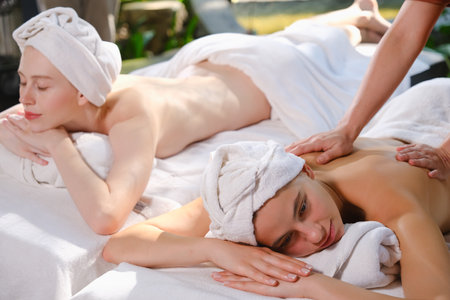 Young woman getting a back massage at spa center. Focus on womanの写真素材