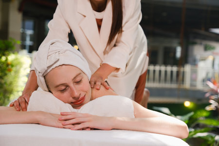 Relaxed young woman receiving a head massage at a spa centreの写真素材