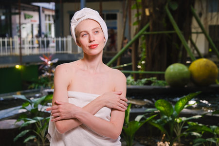 Portrait of a young beautiful woman with a towel on her head.の写真素材