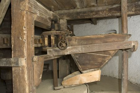 Old windmill inside with millstone and wooden gears.の写真素材