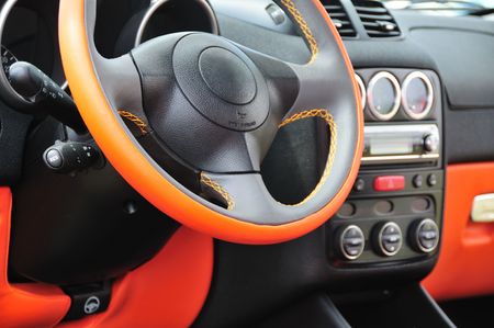 Modern car interior with orange steering wheel.の写真素材