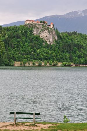 Castle and empty bench in Bled (Slovenia) in the summer.の写真素材