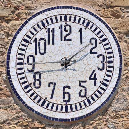 Detail of church clock with sun shadow - quarter to two.