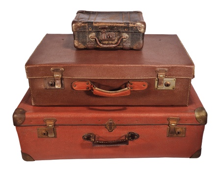 Three old suitcase stacked with different size, isolated on white.の写真素材