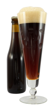 Full glass of dark beer isolated on white.の写真素材
