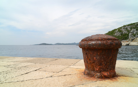 Rusty metal mooring bolard for big ship.の写真素材