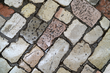 Wet ancient cobblestone floor detail for background.の写真素材