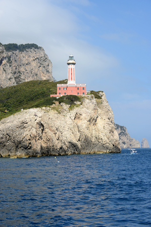 Punta Carena, a red lighthouse on the island of Capri (Italy).の写真素材