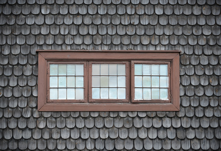 Closed old brown windows on wooden tile.の写真素材