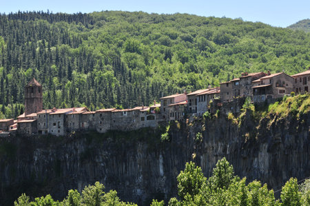 Castellfollit de la Roca is one of the most picturesque villages in Catalonia. Houses cling to the top of a spectacular basalt rock faceの写真素材