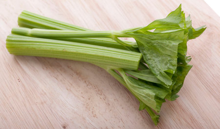 Fresh celery stalks on a white background