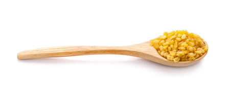 Hulled-split monk bean in wooden spoon isolated on white backgroundの写真素材