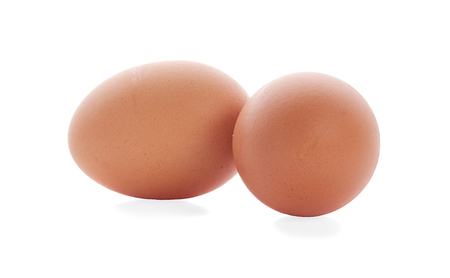 Two fresh hen eggs isolated against a white background.の写真素材
