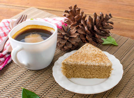 A glass cup of black coffee with cake on a  backgroundの写真素材