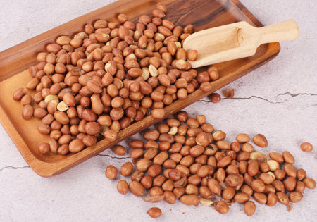 peanuts in wooden tray on wood