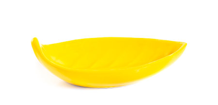 Yellow ceramic bowl isolated on white backgroundの写真素材