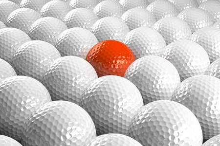 3d White Golf balls & one orange in the middleの写真素材