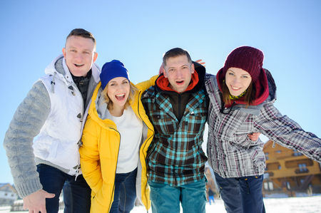 Cheerful group of friends posing for the camera. Two young men and two girl. All good mood. Friends are hugging and laughing merrily.の写真素材
