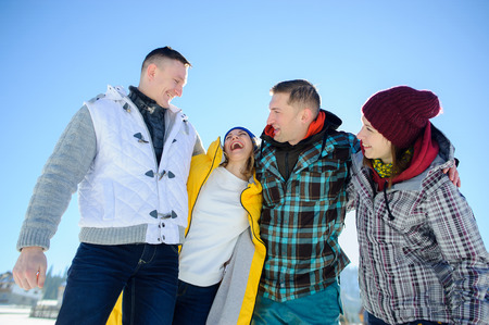 Cheerful group of friends posing for the camera. Two young men and two girl. All good mood. Friends are hugging and laughing merrily.の写真素材