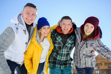 Cheerful group of friends posing for the camera. Two young men and two girl. All good mood. Friends are hugging and laughing merrily.の写真素材