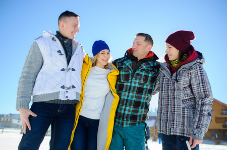 Cheerful group of friends posing for the camera. Two young men and two girl. All good mood. Friends are hugging and laughing merrily.の写真素材