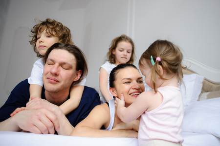 Morning in a big family. Father, mother and three children cheerfully begin new day.の写真素材