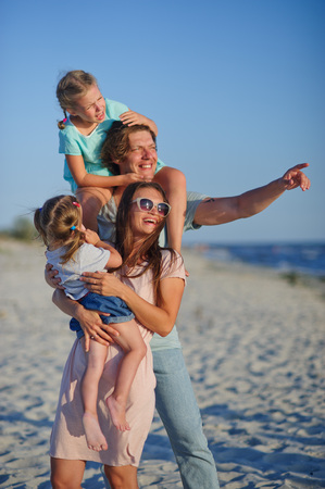 Young happy family on the beach.の写真素材