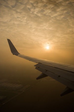 The sun is through the clouds. View from the airplane window.の写真素材