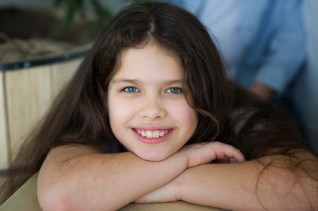 Portrait of a girl 10-11 years old. ?ute girl looks at the camera and smiles.の写真素材