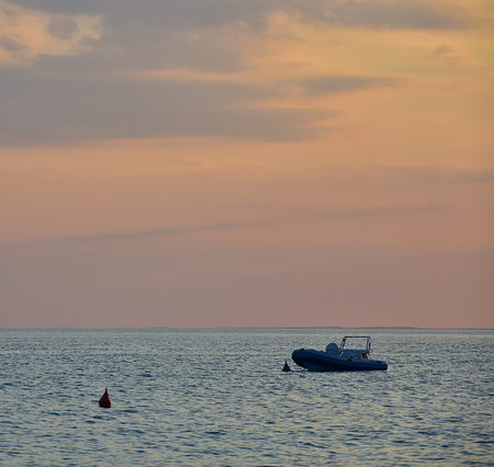 Boat on the Adriatic sea with beautiful sunset background