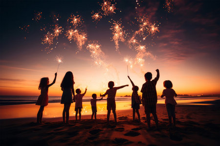 Silhouette of happy family with sparklers on the beach at sunsetの素材