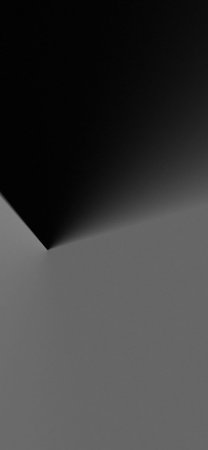A minimalist abstract background featuring a stark contrast between black and gray, with a sharp...