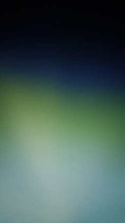 A visually appealing abstract background featuring a smooth gradient of colors, transitioning from dark blue to green and light blue, creating a serene and modern aesthetic.の写真素材