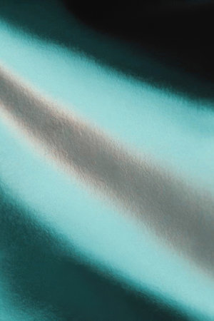 A close-up abstract view of a textured surface with smooth, flowing diagonal lines in teal, grey, and black, suggesting movement and depth.の写真素材