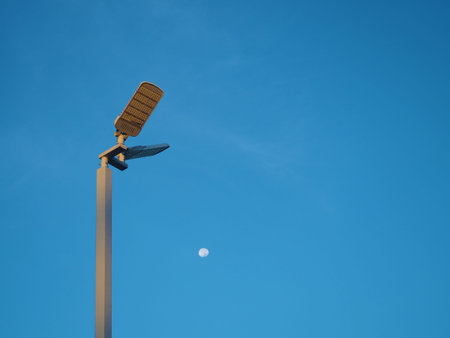 The spotlight tower on the background is a blue sky And there is a small moon in the middle.Energy...