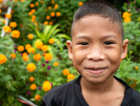 Boy smiling face portrait On a garden background.の写真素材