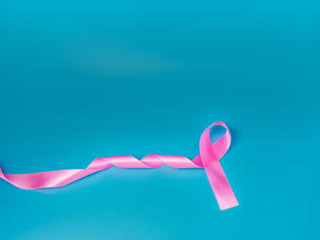 Pink ribbon On a blue background Conveys the awareness of cancer. World cancer day concept.の写真素材