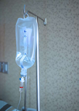 Saline jar hanging in a steel pole in the hospital. Health and medical equipment concept.の写真素材